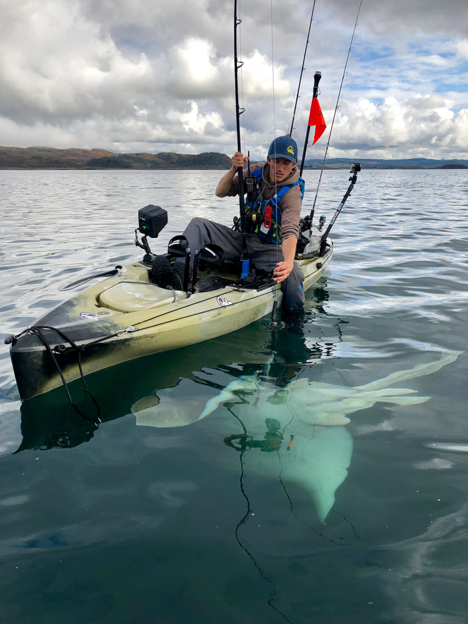 A Giant Skate rises from the depths beside the kayak