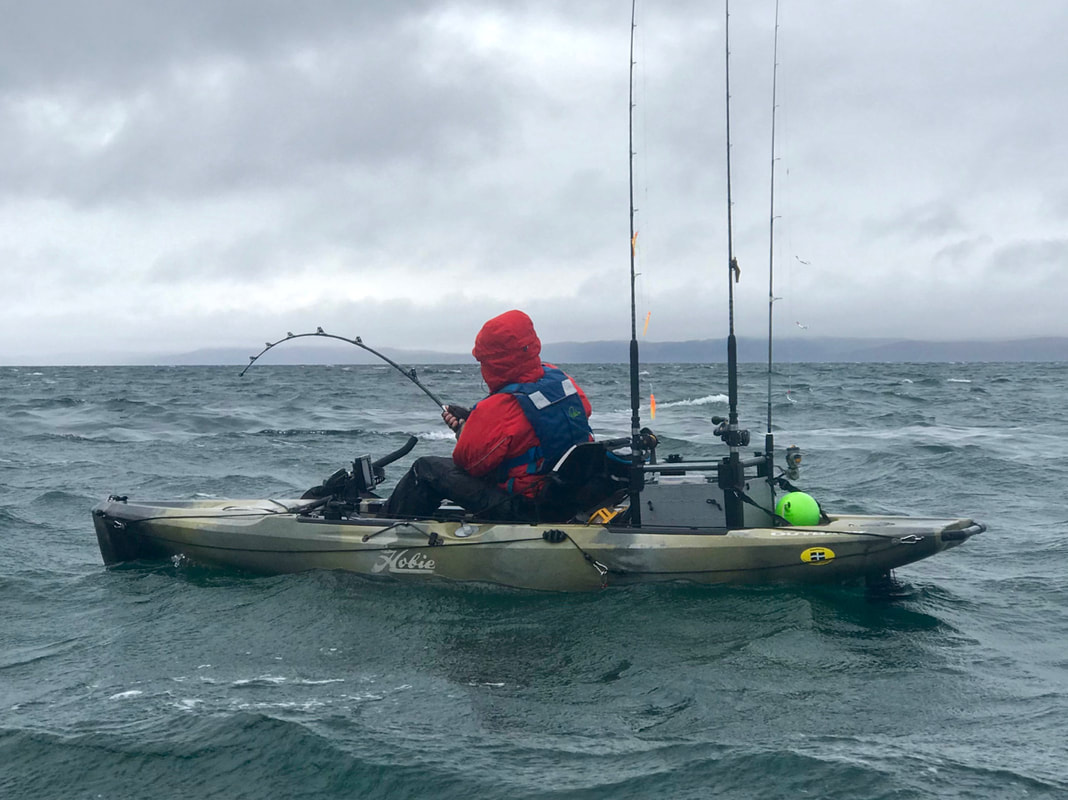 Ben Wallis playing a skate from his Hobie Outback kayak in rough weather