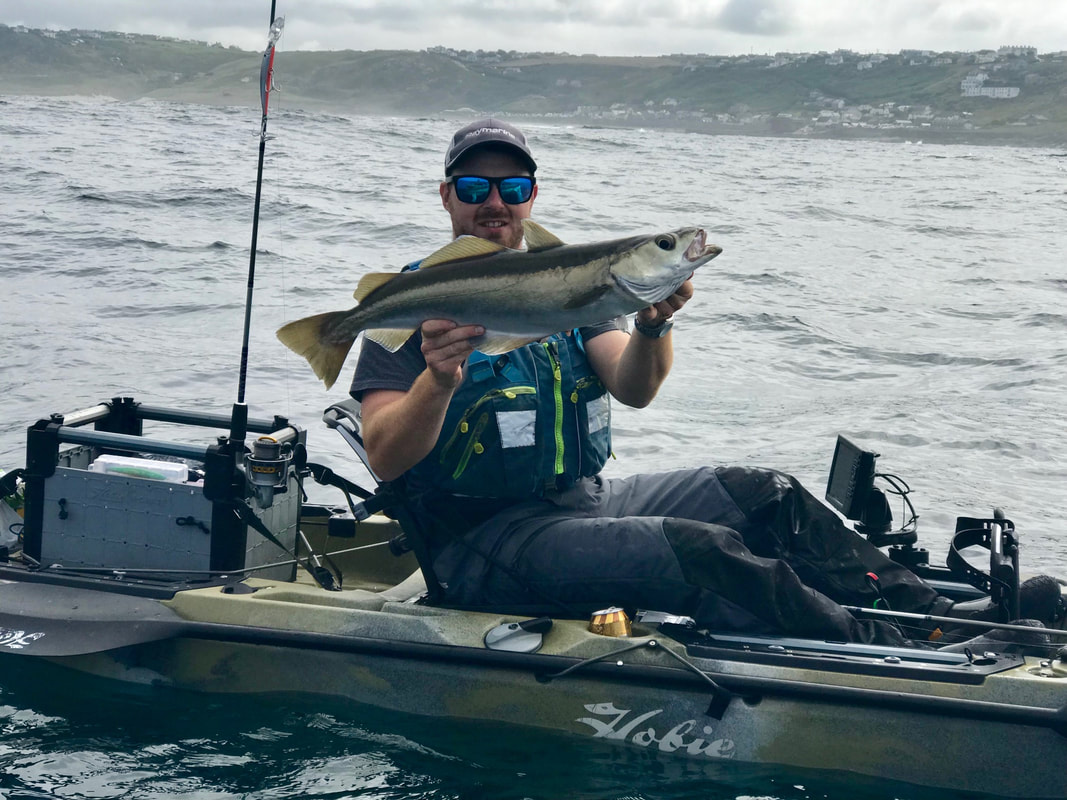 Ben with a Pollack caught at the Penzance Kayak Fishing Meet 2019