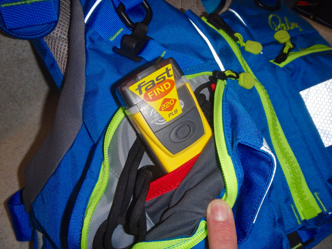 A PLB personal location beacon in a buoyancy aid pocket