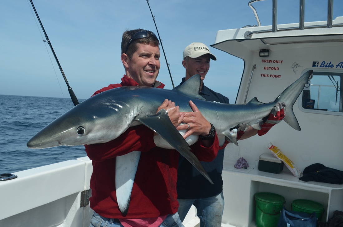 Scott with a 60lb Blue Shark caught on Bite Adventures