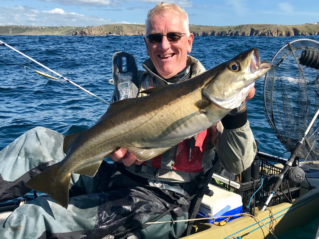 Stu with a 9lb Pollock caught at the Penzance Kayak Fishing Meet